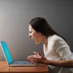 screaming angry woman with laptop